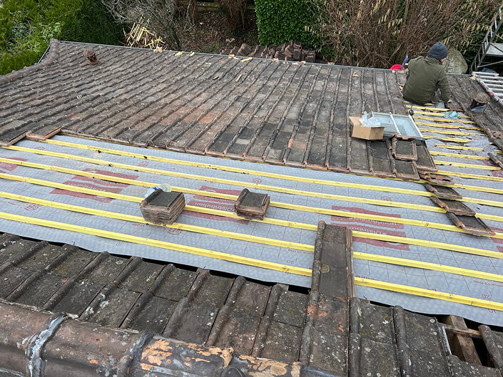 Technique de pose pour l'amélioration du confort thermique Pose de rouleaux d'isolant par un couvreur en Essonne